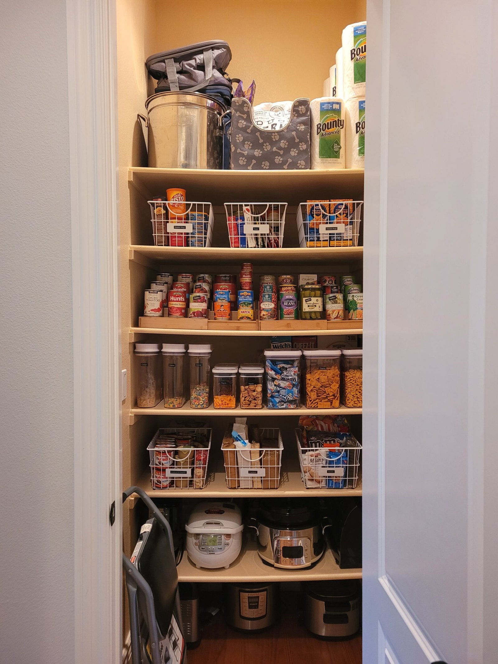 After Organization Image of Pantry with everything neatly placed, binned, and labeled