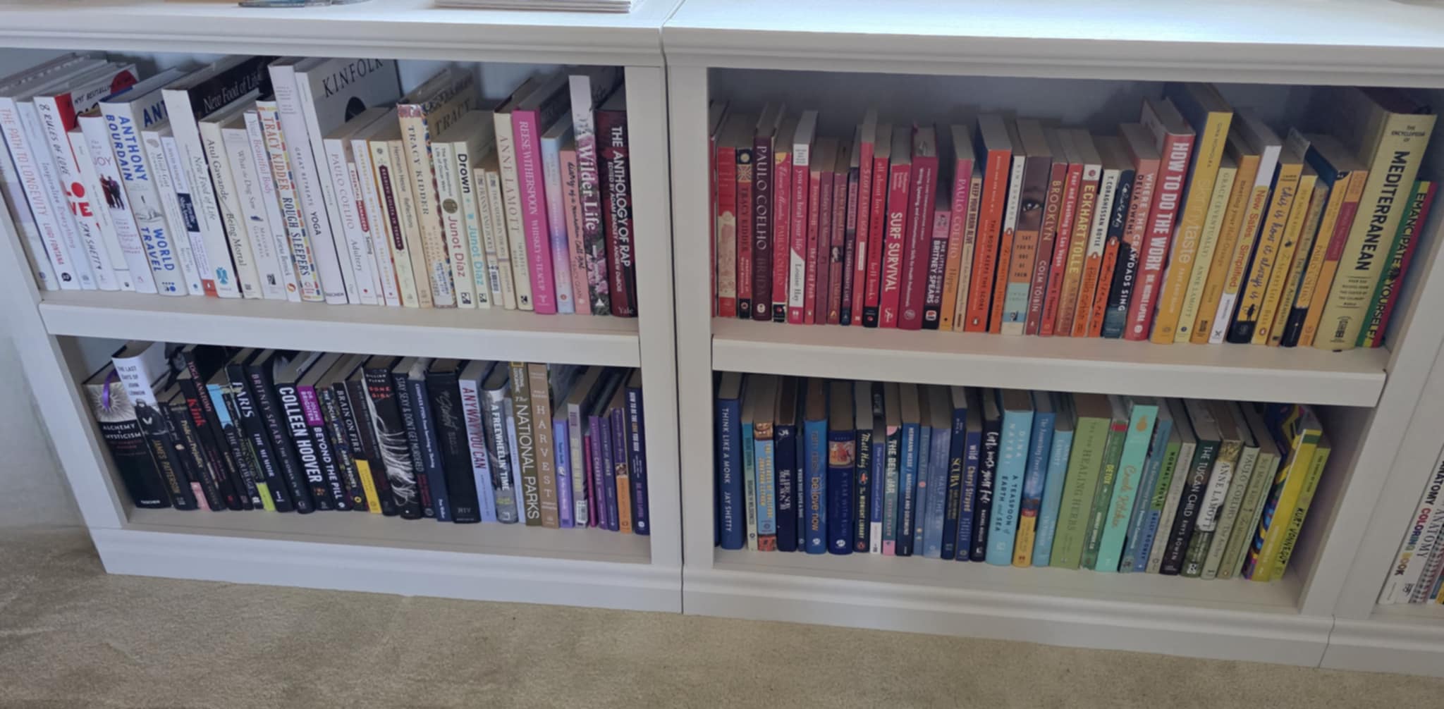 Bookshelf with books arranged in rainbow color order