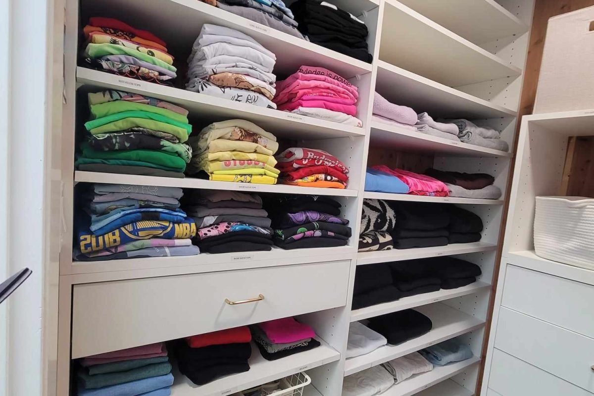 Primary closet organization with everything neatly folded and color-coded