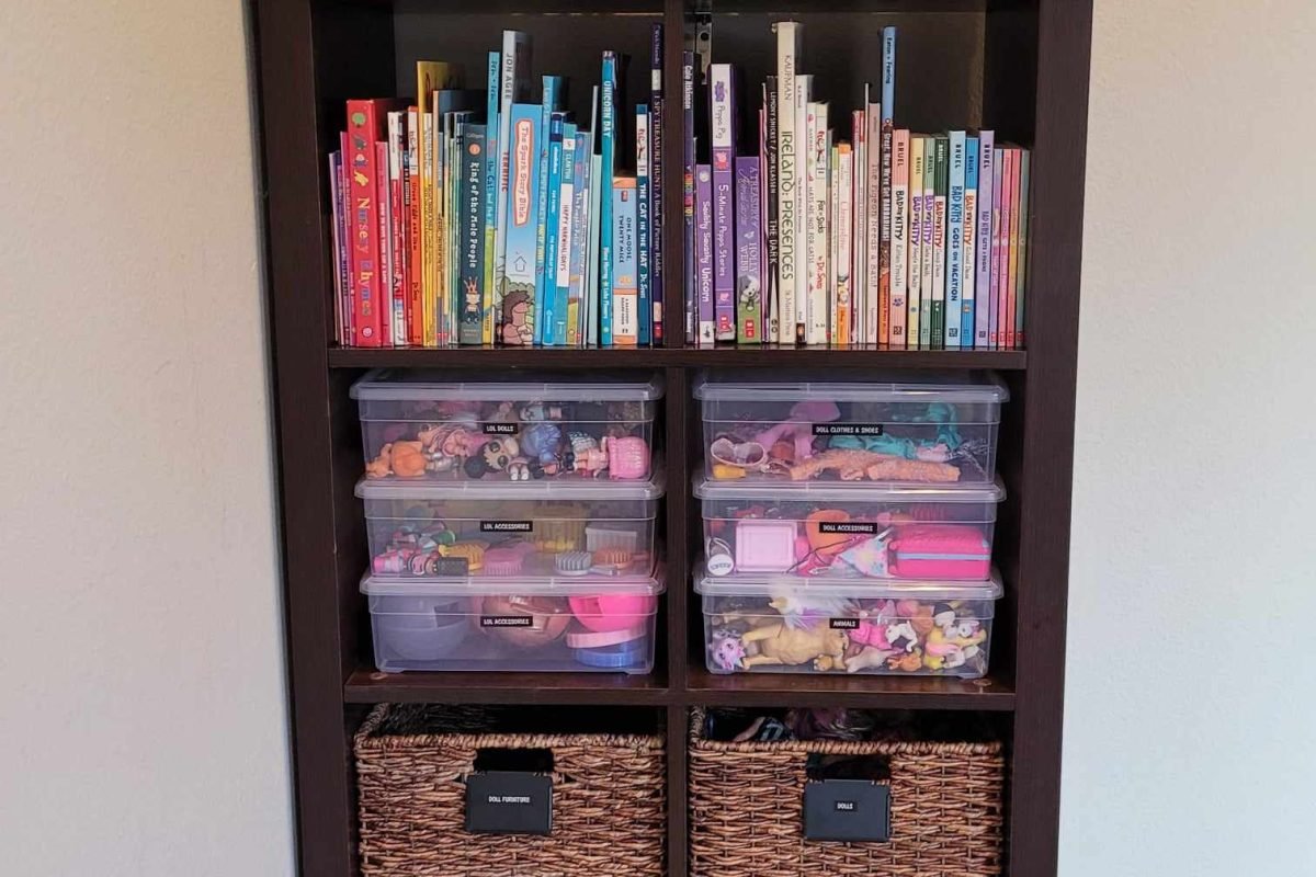 After organization image of kid's playroom shelf with binned and labeled toys and books in rainbow order