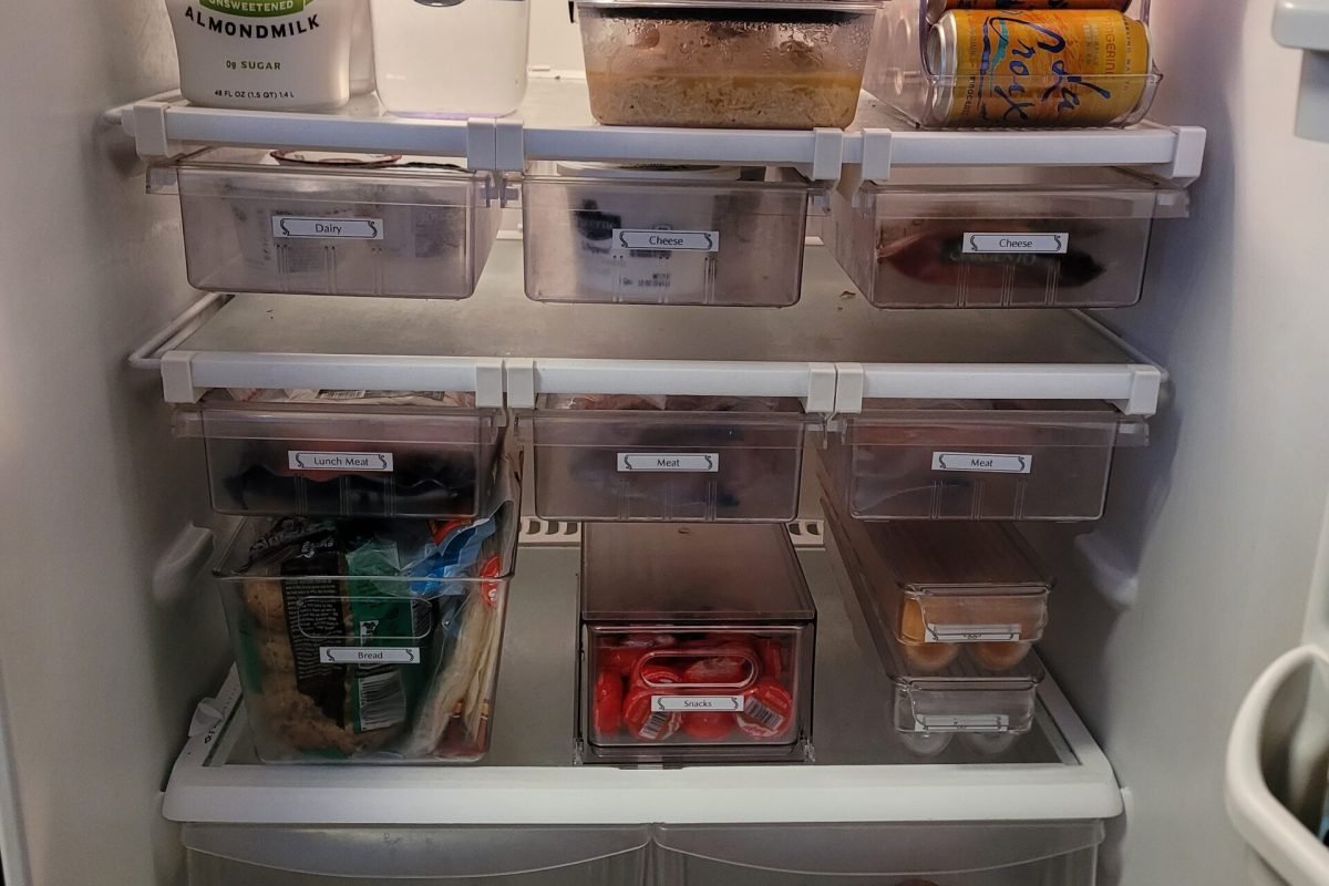 Refrigerator organized with bins and drawers all labeled and categorized